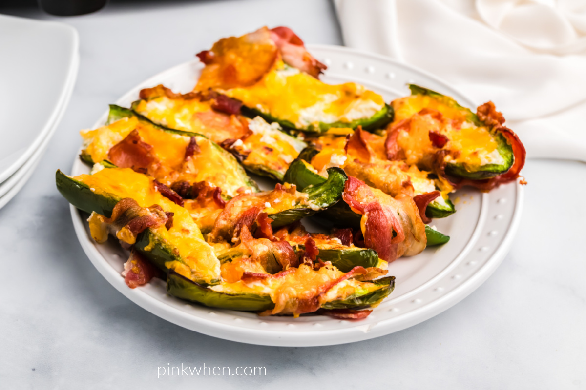 Air Fryer Bacon Wrapped Jalapenos on a white plate ready to serve. 