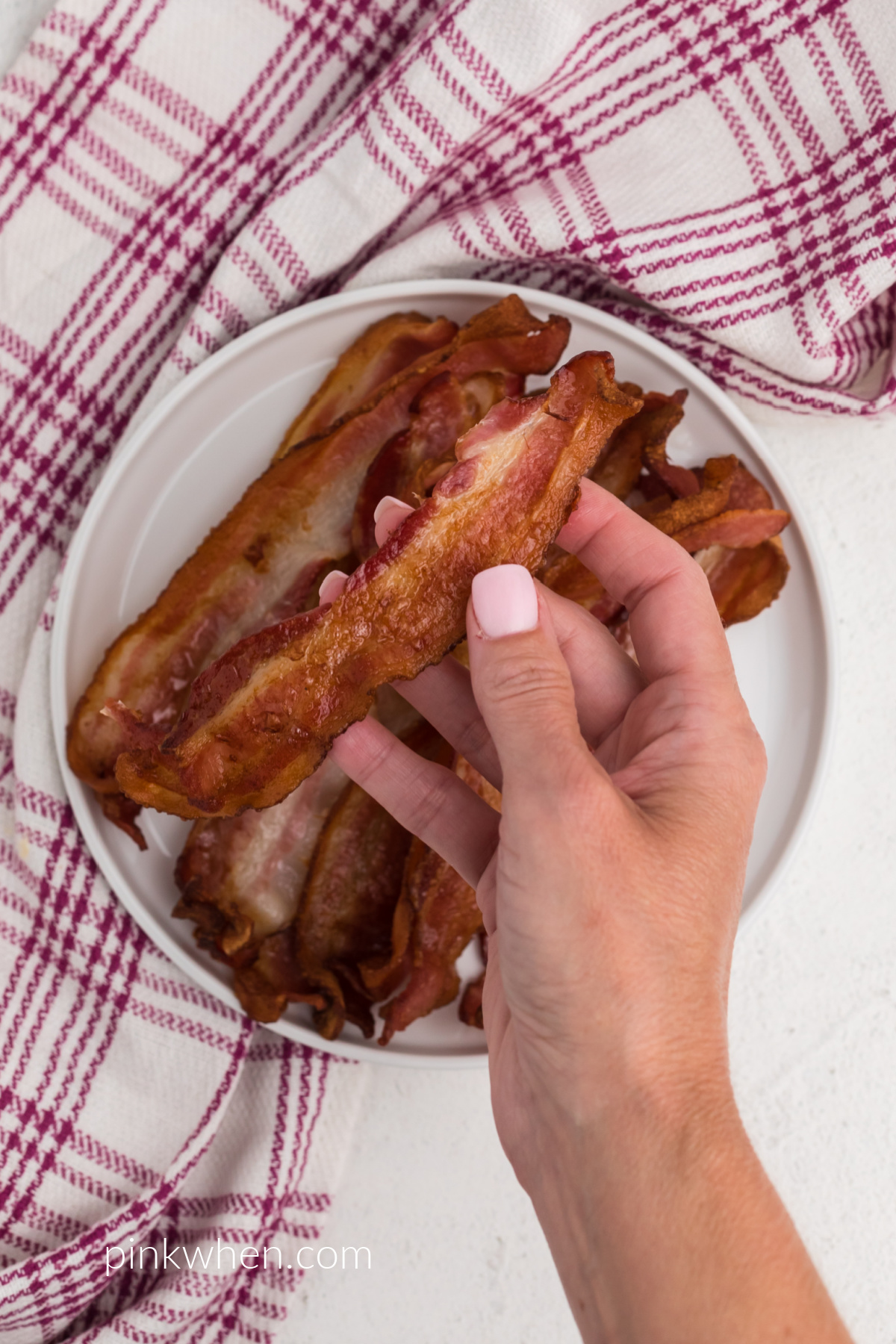 Crispy Air Fryer bacon on a plate and ready to eat. 