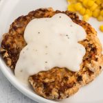 Air Fried Chicken Fried Steak topped with white gravy on a white plate ready to serve.