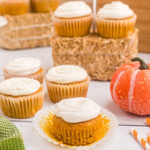Pumpkin spice cupcakes on a board ready to eat.