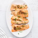 Salmon made in the air fryer on a white serving tray.