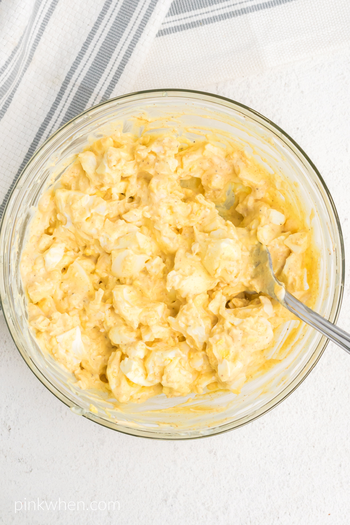 Ingredients combined in a bowl to make egg salad. 