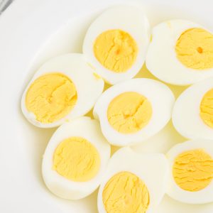 AIr Fried Boiled eggs cut in half and served on a white plate.