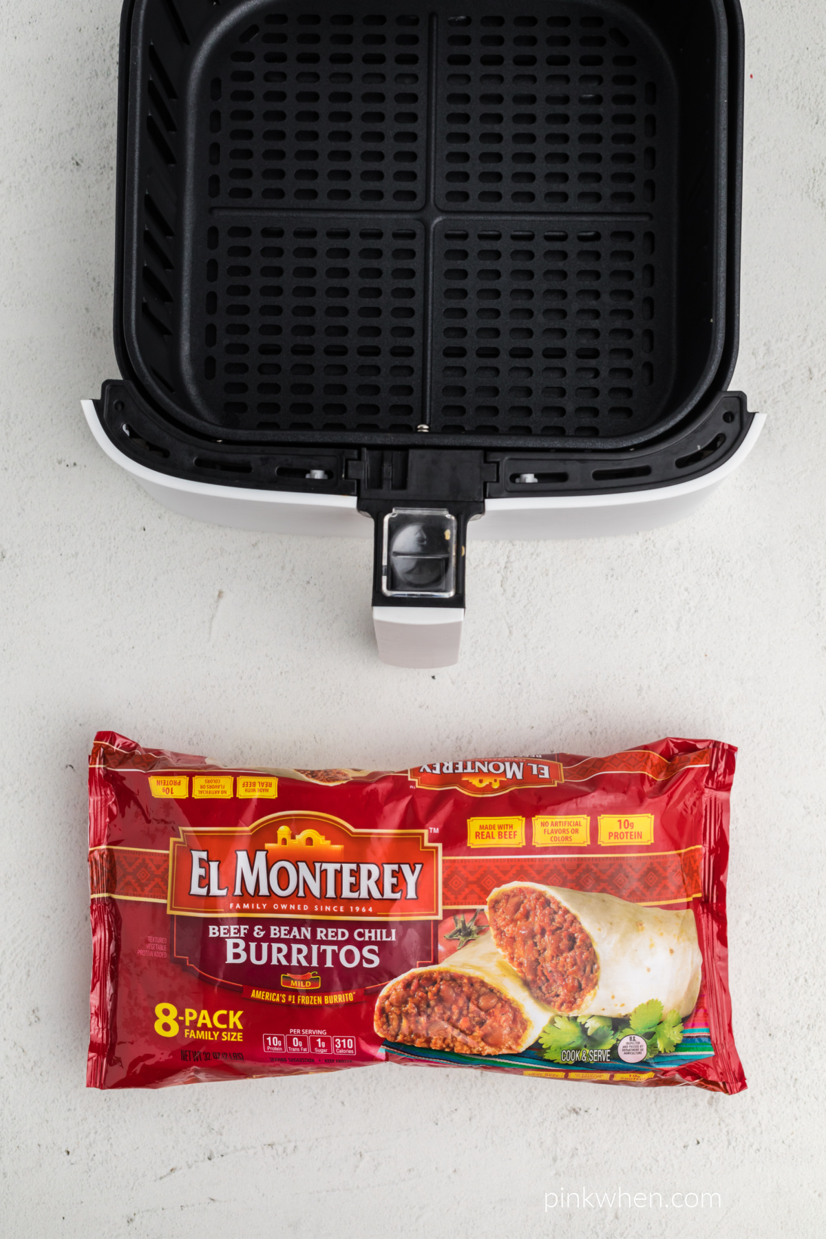 Empty air fryer basket and a package of El Monterey frozen burritos.