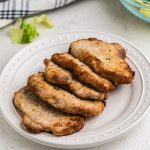 Air Fryer Pork Chops without breading on a white plate ready to serve.