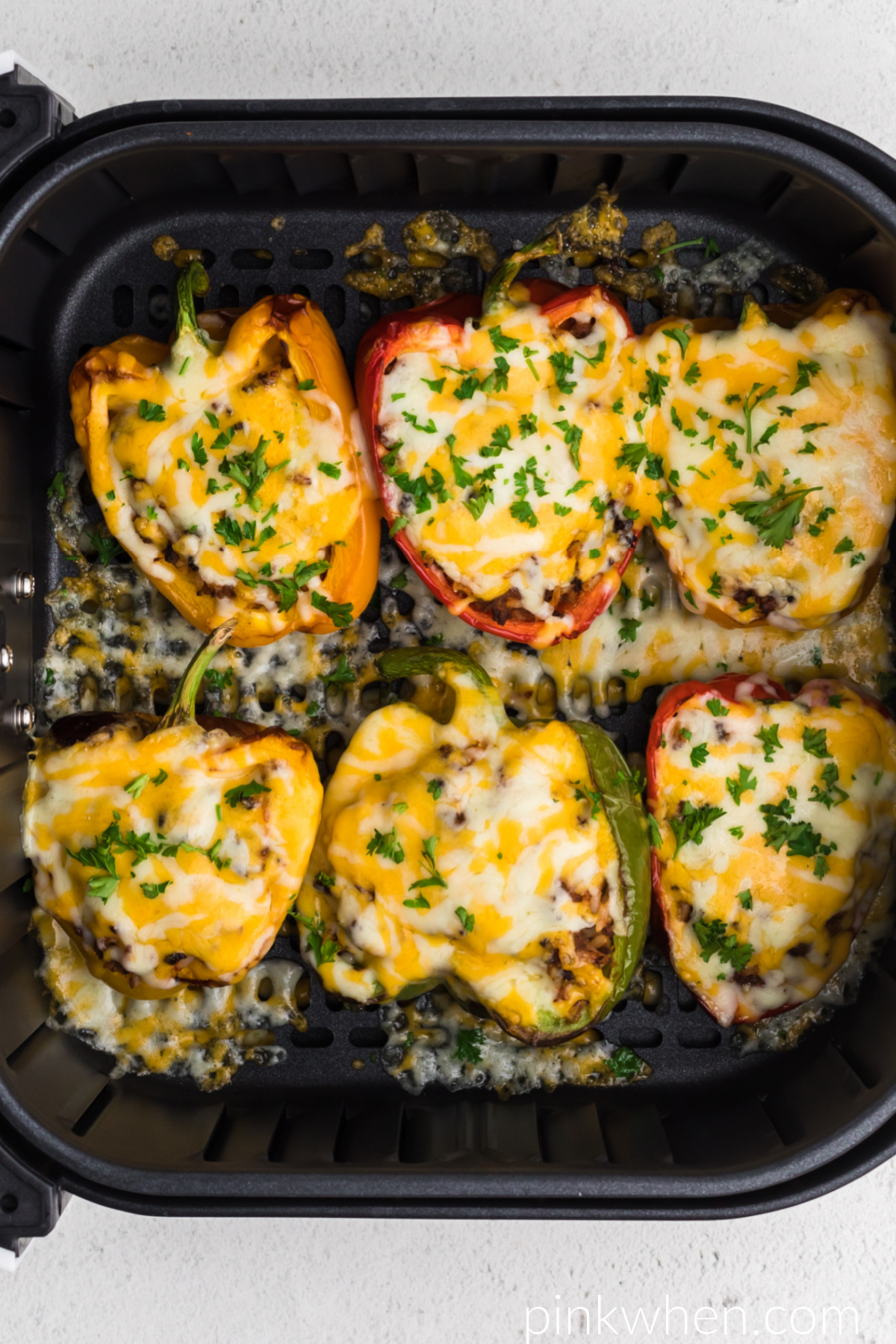Air Fryer Stuffed Peppers topped with cheese and fresh parsley before serving. 
