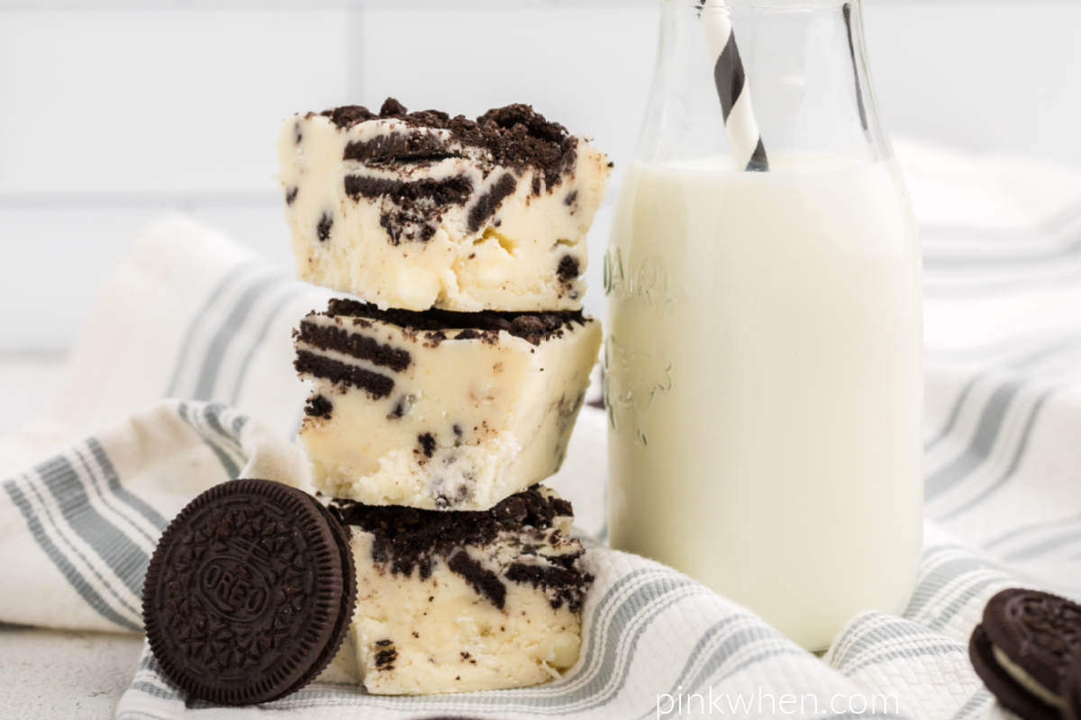 OREO cookie fudge stacked next to a glass of milk. 