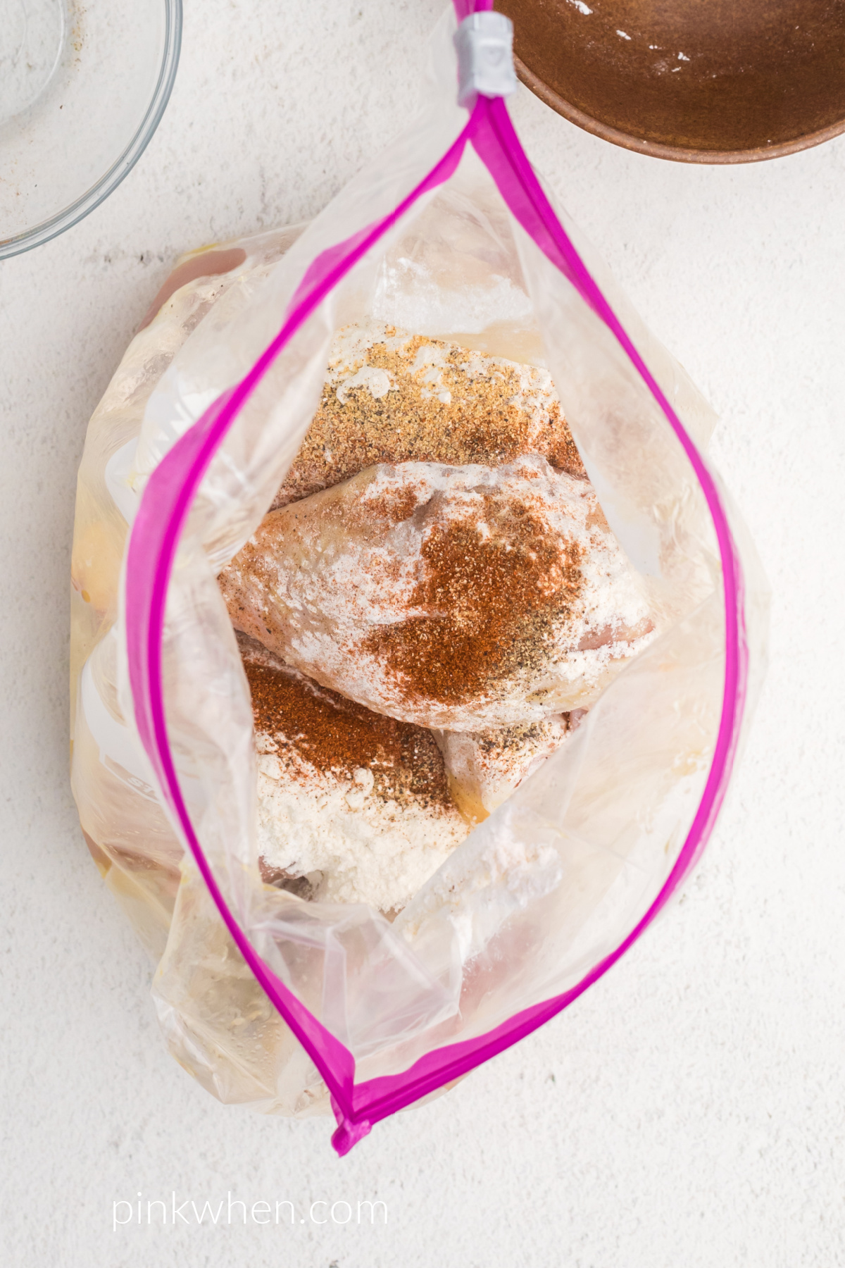 Drumsticks in the bag that are being seasoned and ready to be placed in the air fryer.
