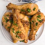 Garlic Air Fried chicken drumsticks on a white plate ready to serve.
