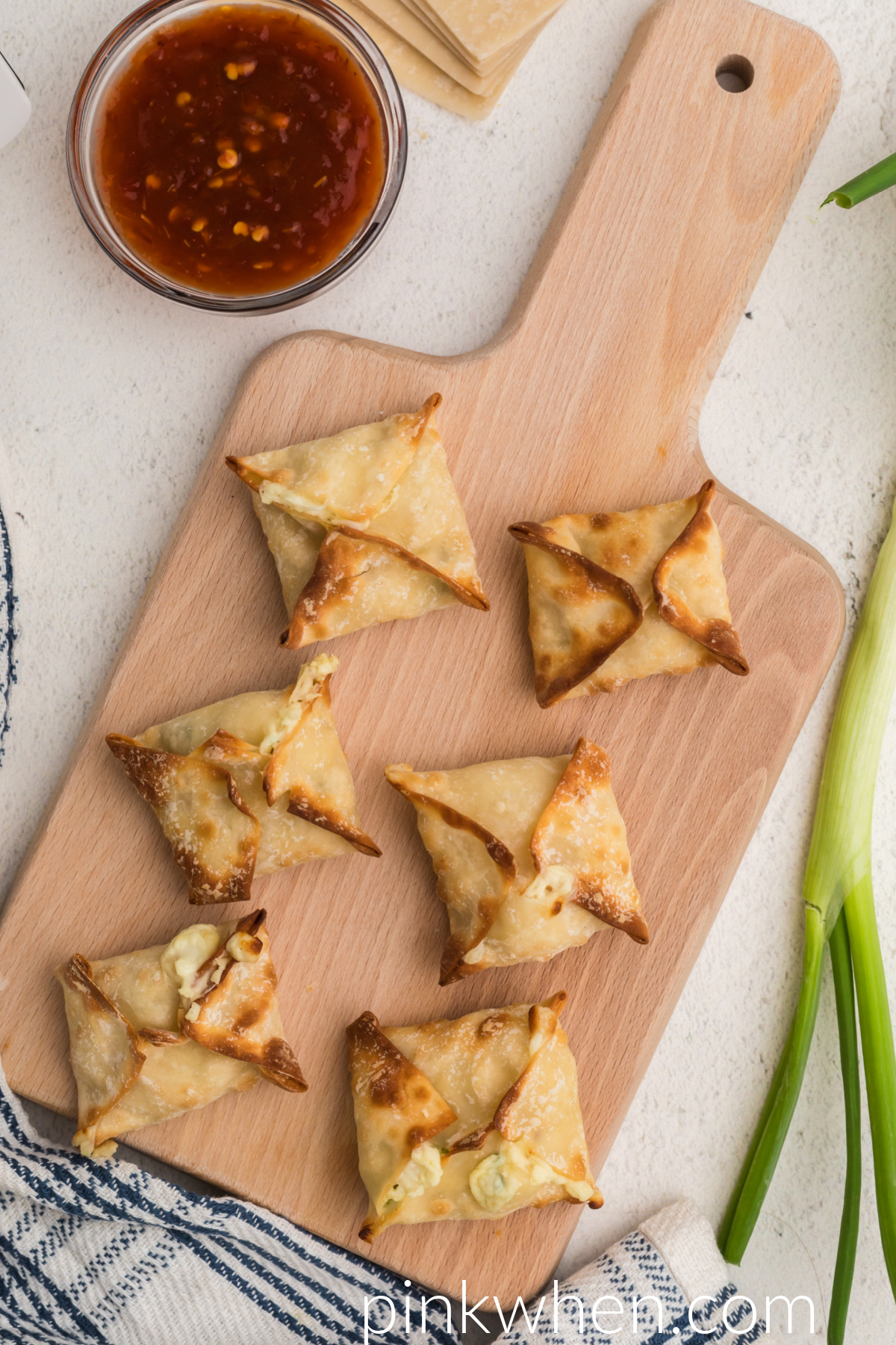 Air Fried Crab Rangoon on a cutting board ready to be served. 