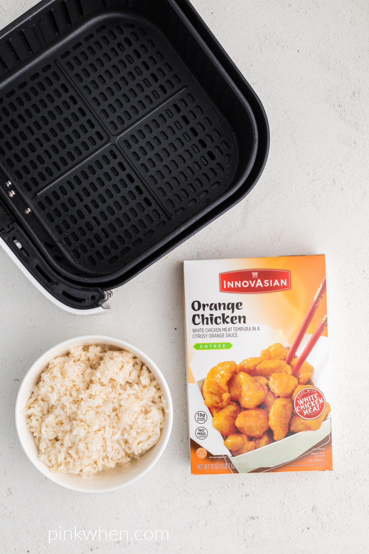 Orange chicken frozen in a box and a bowl of rice. 