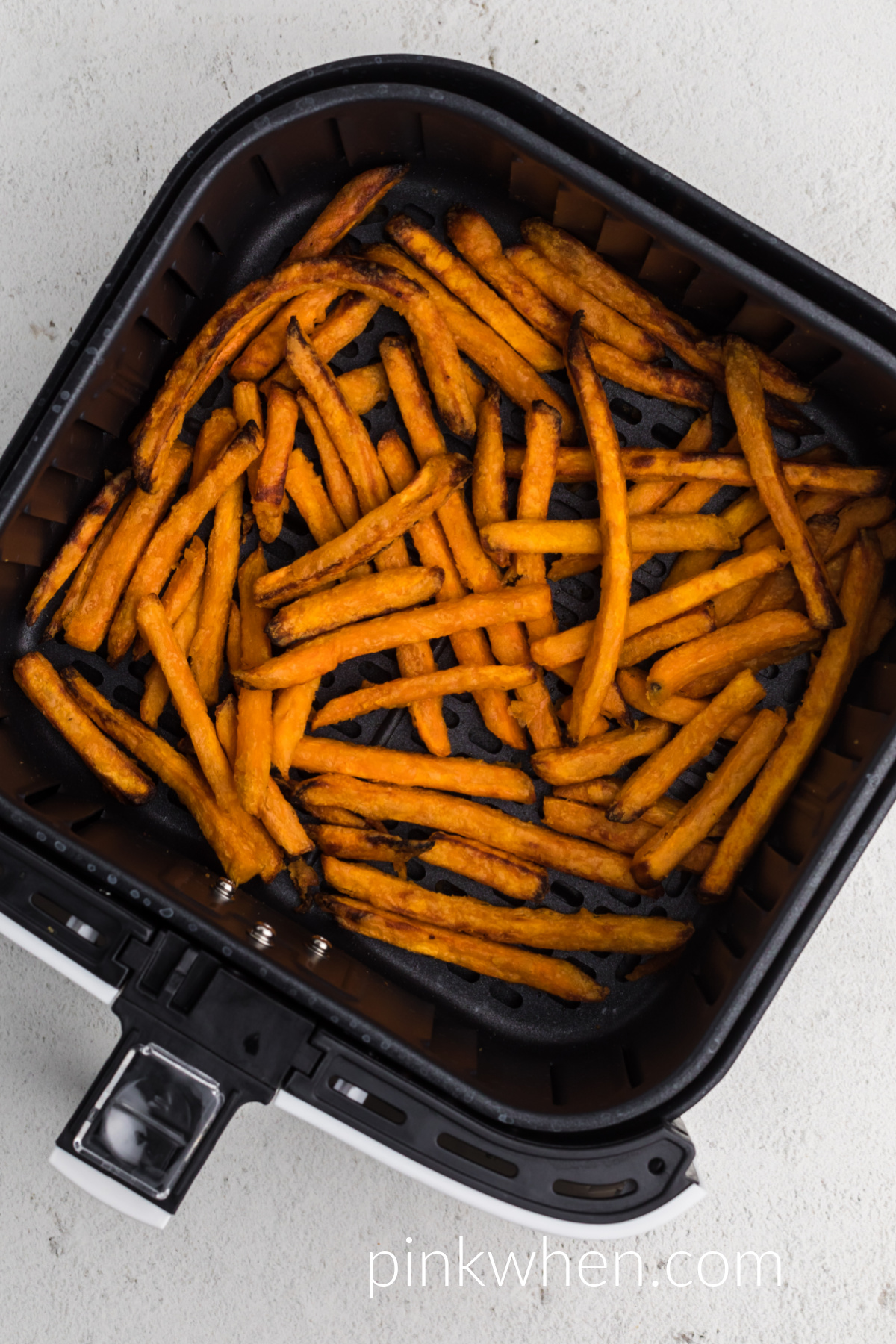 cooked from frozen Sweet potato fries in the basket of the air fryer.
