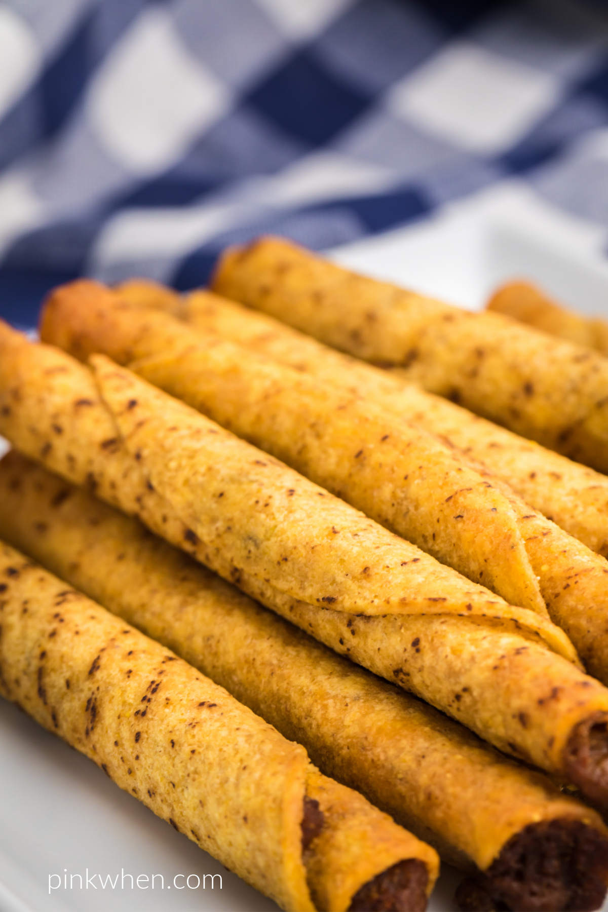 Close up photo of air fried taquitos on a plate ready to eat. 
