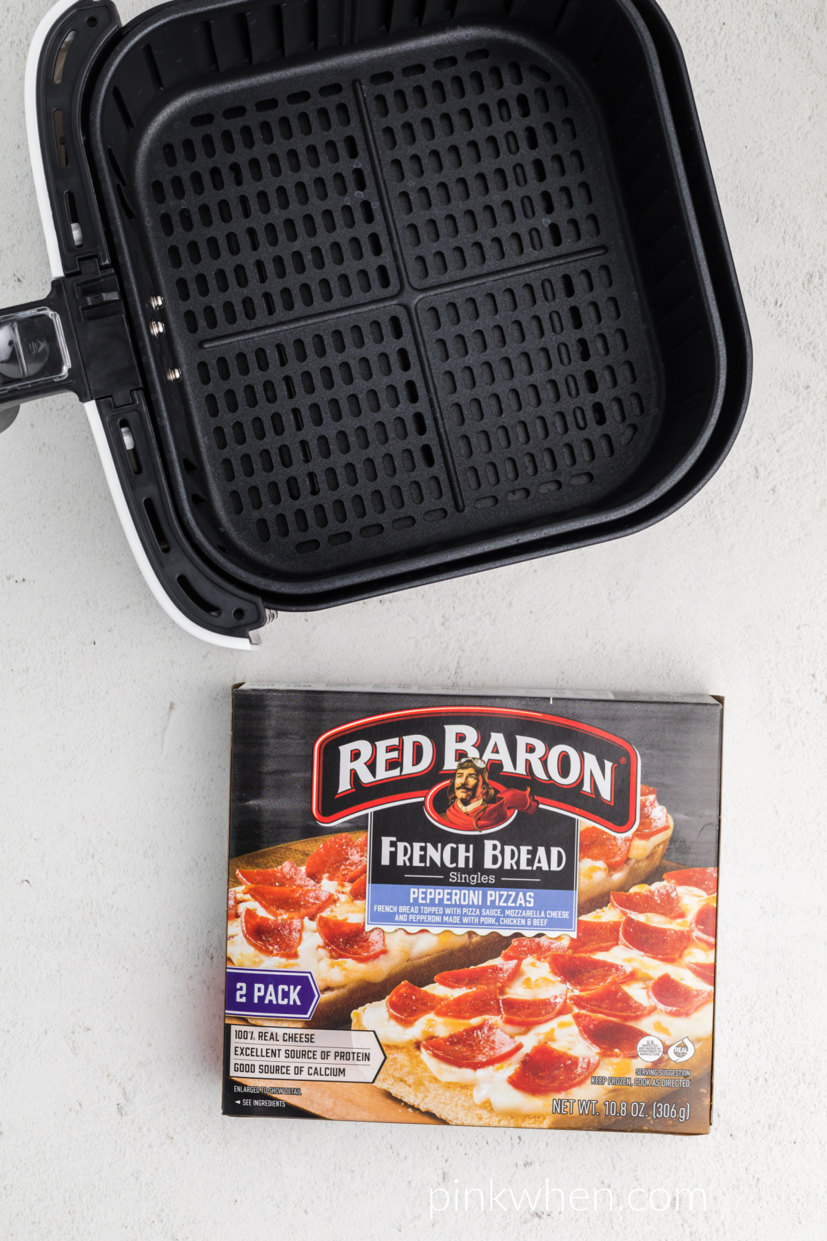 Box of red baron french bread pizzas and the air fryer basket. 