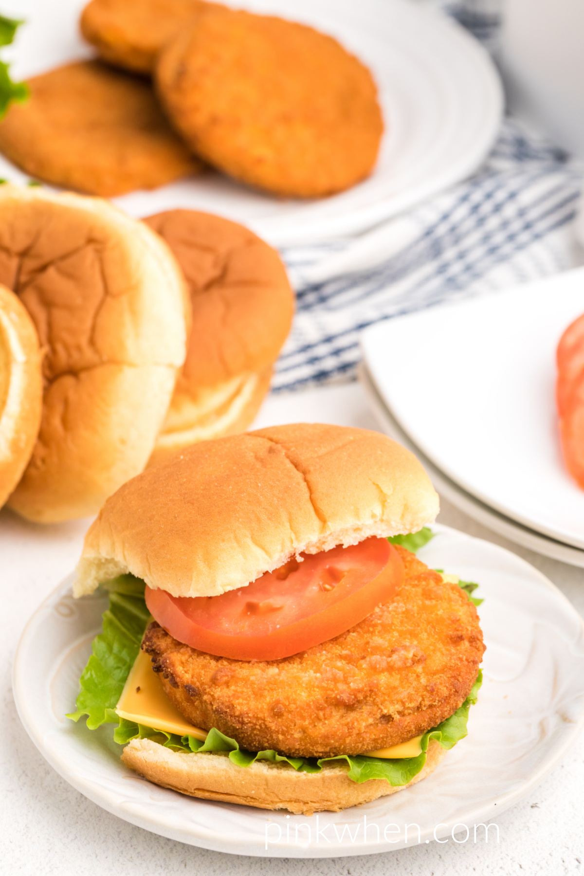 Fully cooked chicken pattie made in the air fryer and dressed with a bun, tomato, lettuce, and cheese. 