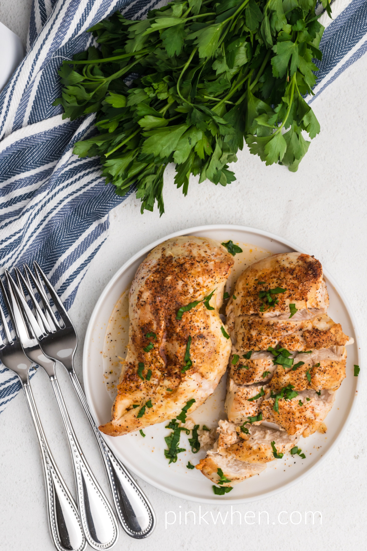 air fryer chicken breast made from frozen, fully cooked and seasoned and served on a white plate.