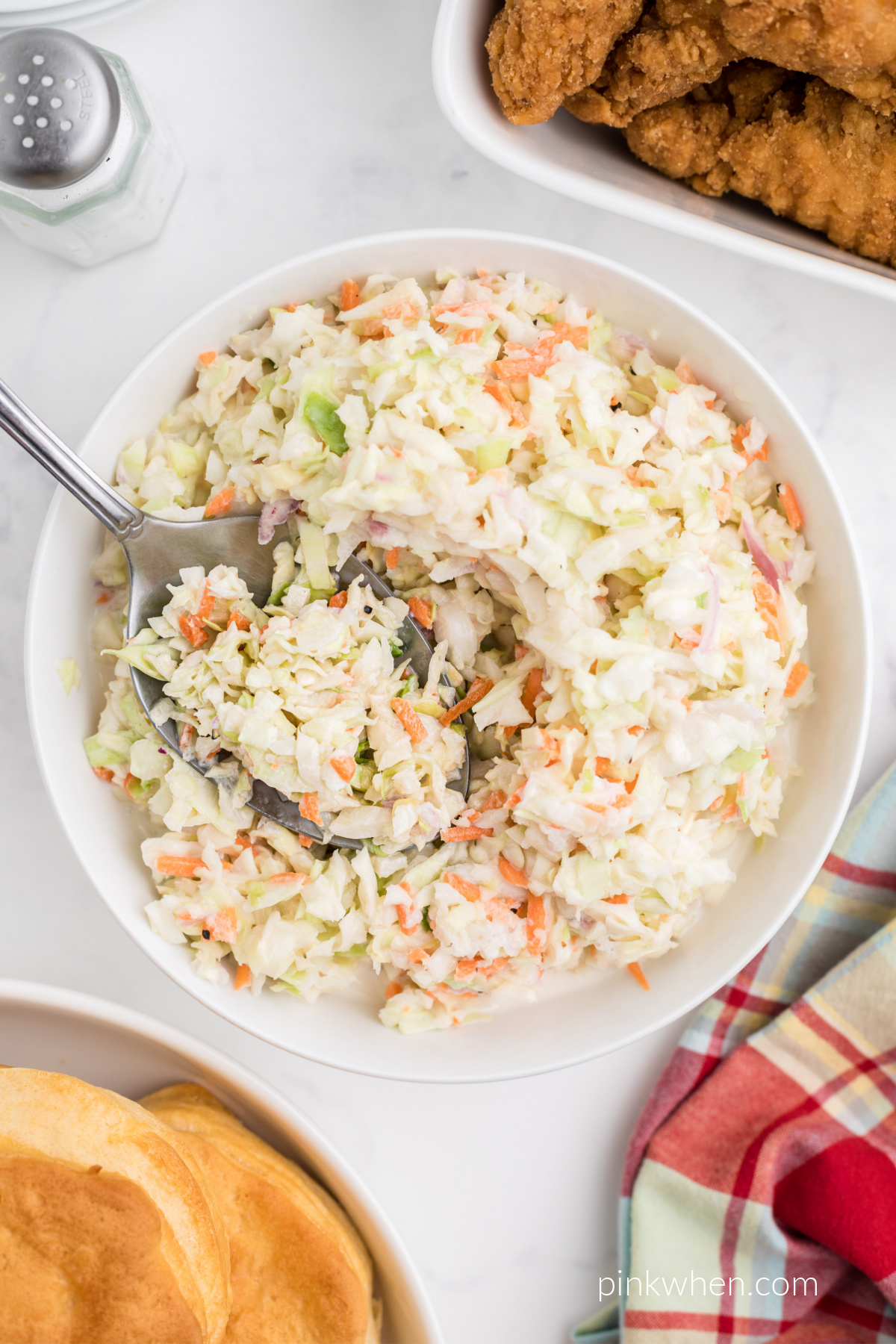 Copycat KFC Coleslaw in a bowl with a serving spoon. 