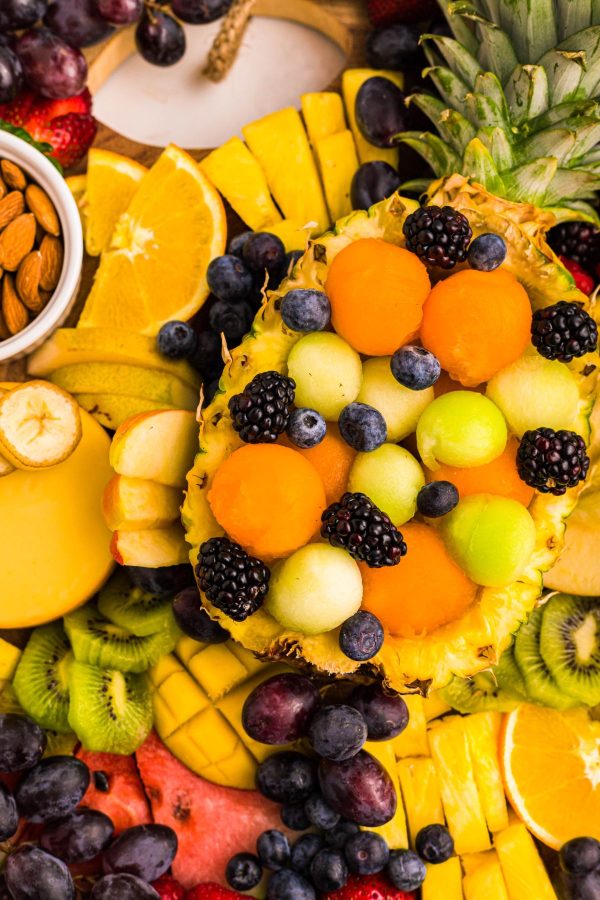 Colorful variety of fruits on a charcuterie board.