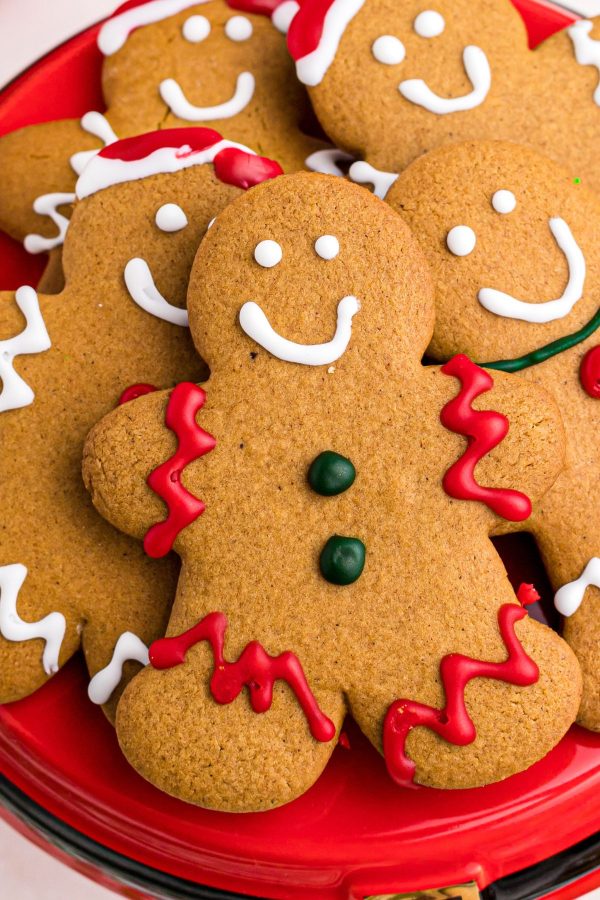 Golden brown gingerbread men cookies decorated with red and green icing. 