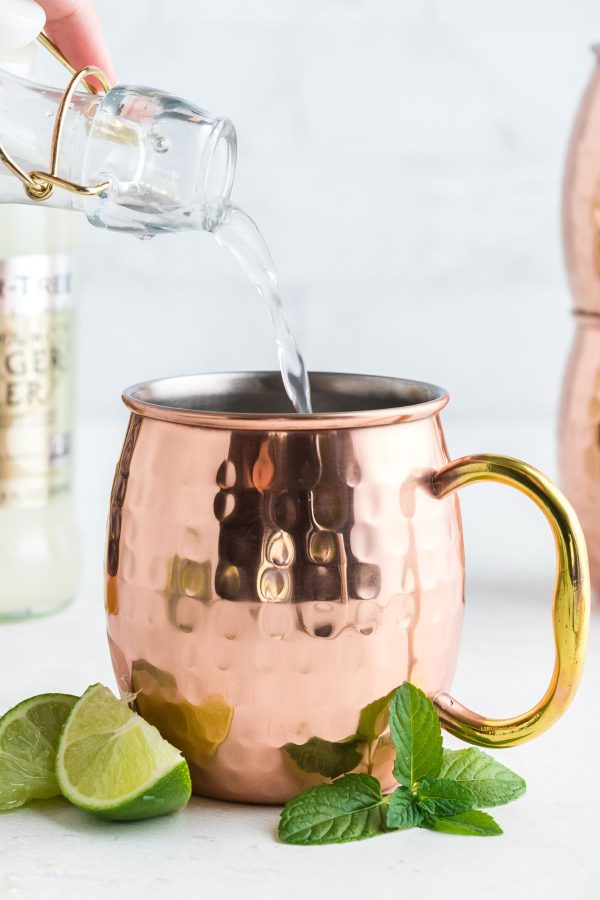 Copper mug with ingredients being poured into the mug