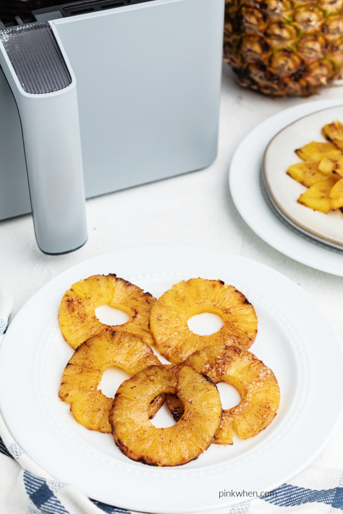 Air fried pineapple on a white plate, ready to serve.