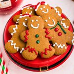Golden brown gingerbread men decorated on a red platter
