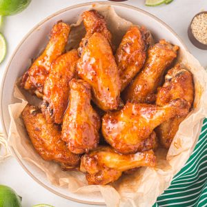 Air fryer chicken wings made with honey sriracha in a bowl ready to serve.