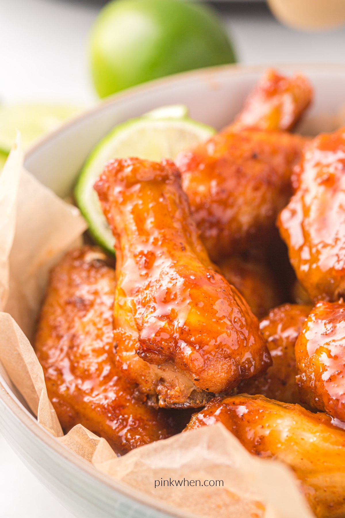 Close up photo of honey sriracha wings in a basket.