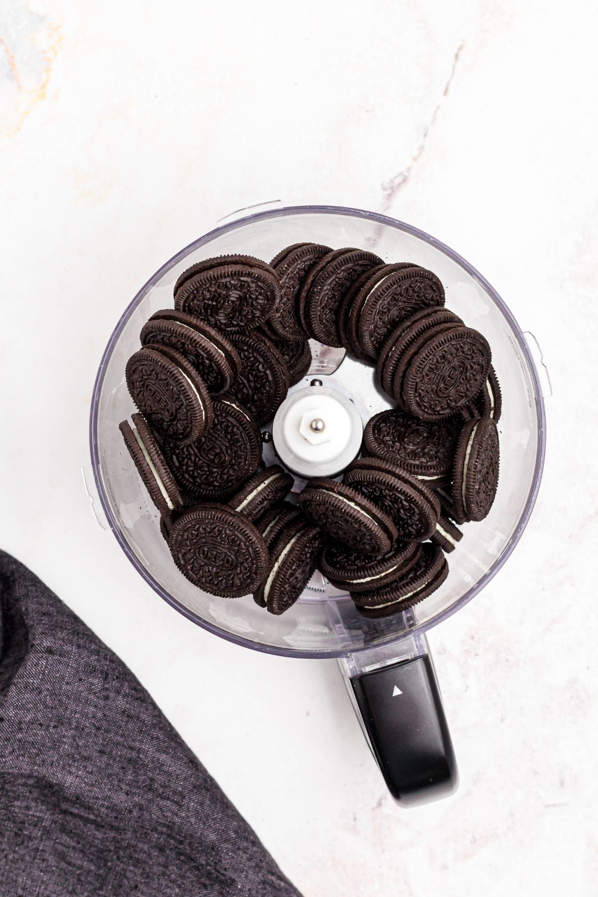 Oreo cookies in a food processor before being chopped.
