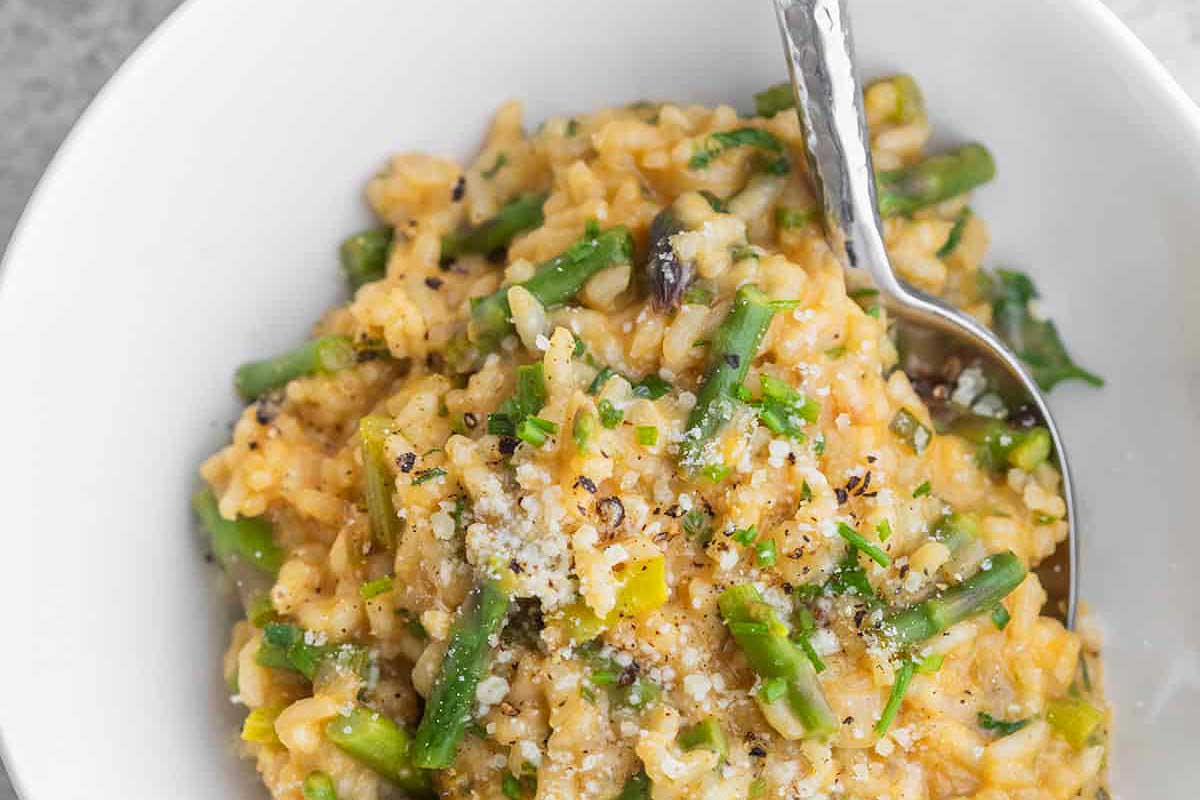 Asparagus risotto in a white bowl.