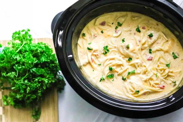 Crock pot chicken spaghetti in slow cooker with parsley.