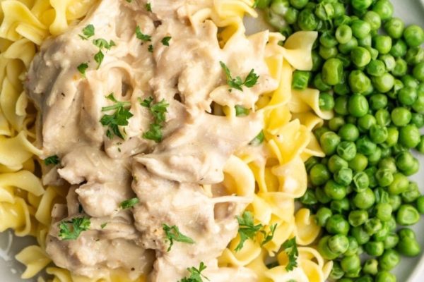 Crockpot chicken and gravy with pasta and peas. 