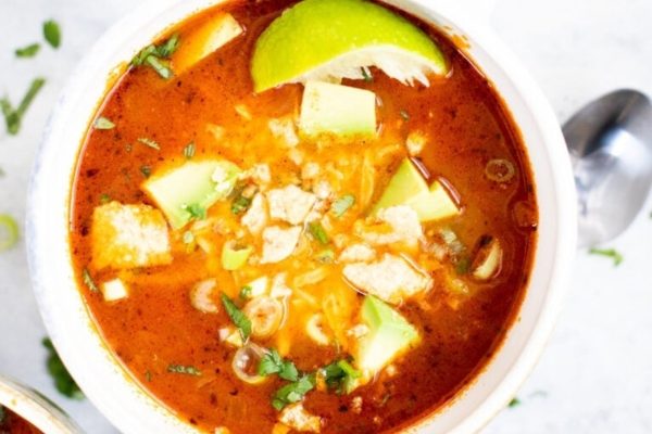 Easy Chicken Taco Soup in a bowl with lemon squeeze.