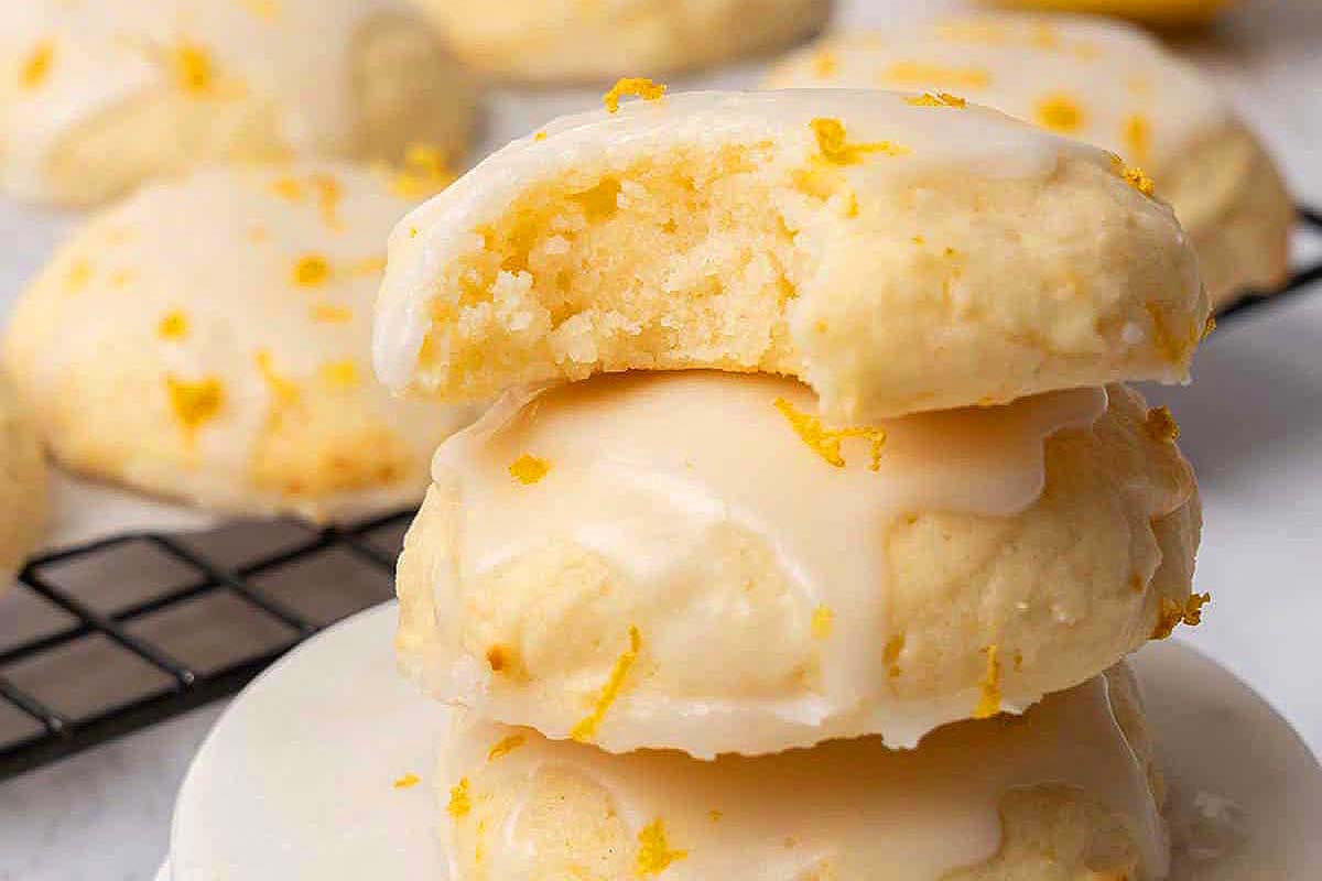 Frosted lemon cookies with lemon zest on top.