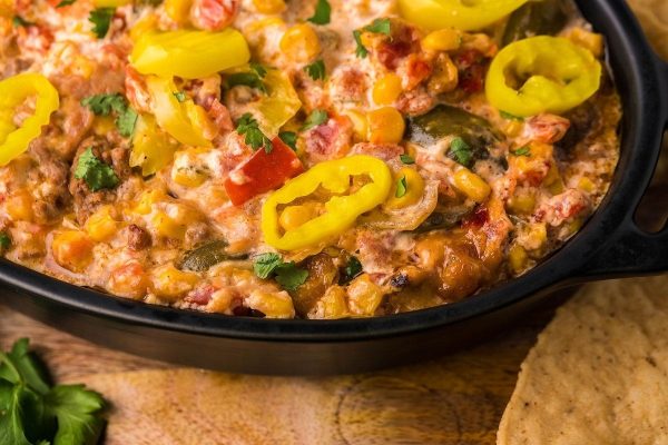 Mexican corn dip in a cast iron pan.