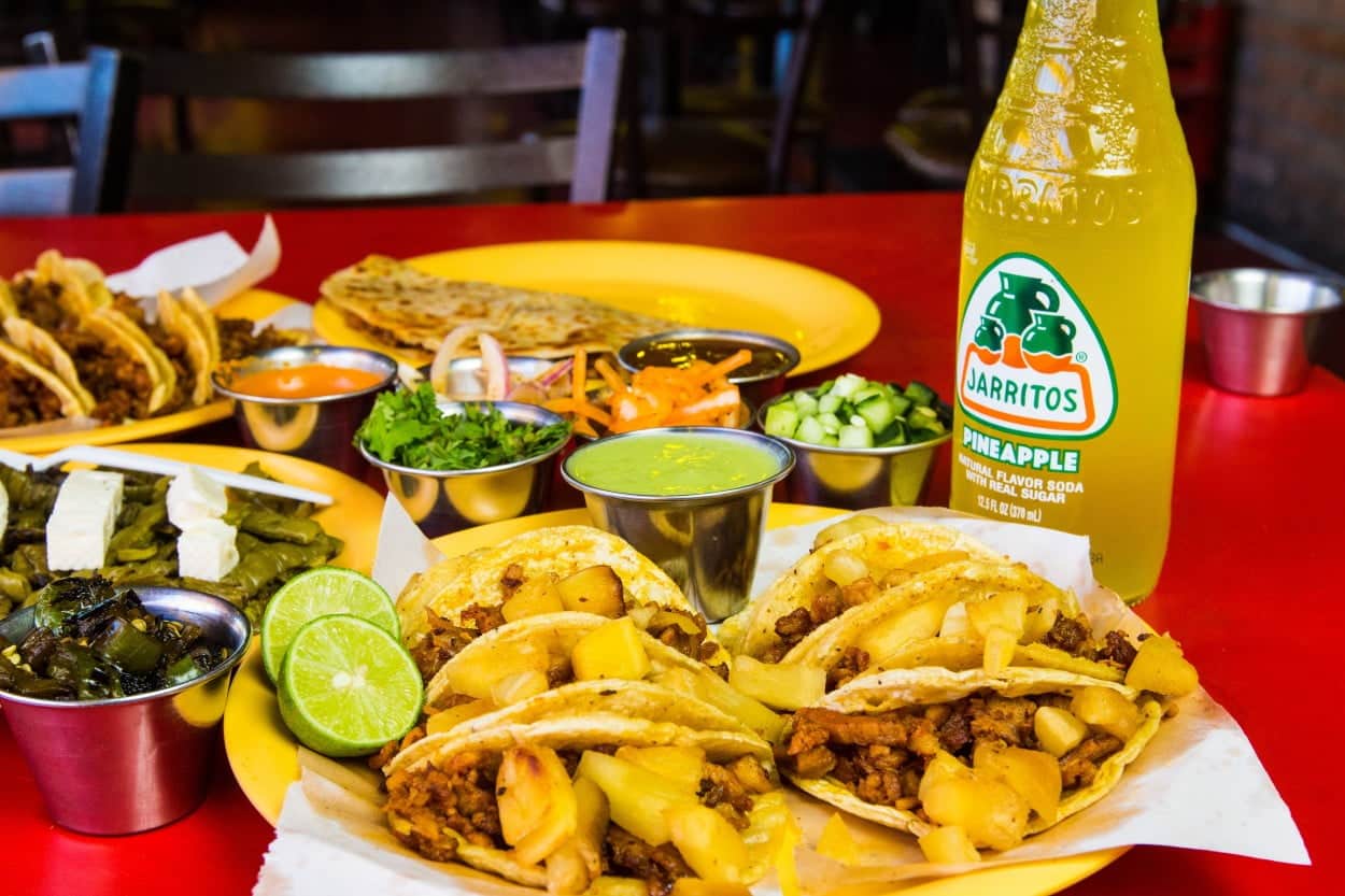 Mexico’s Tacos al Pastor on a plate with jarritos soda drink and salsa.