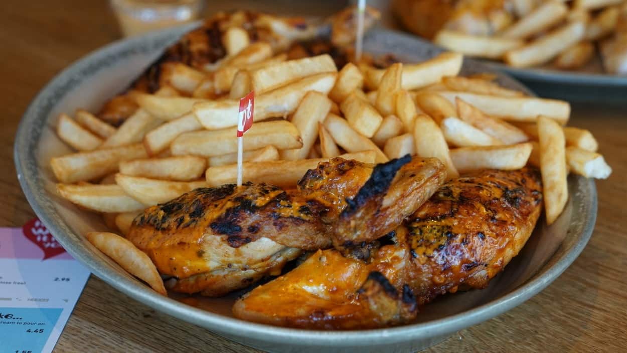Mozambique’s Peri Peri Chicken with french fries on a plate.
