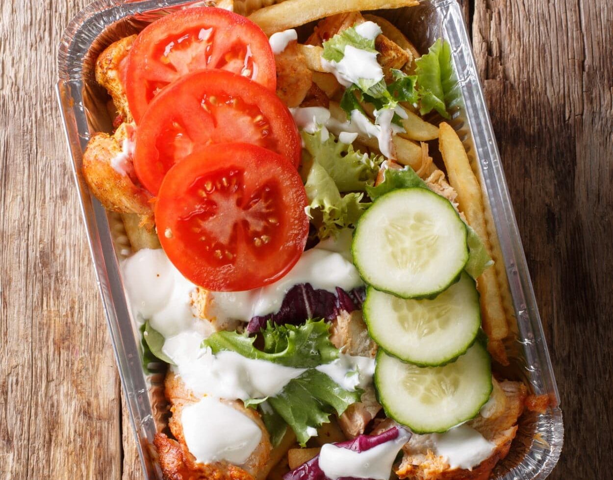 Netherlands`s Kapsalon in an aluminum take-out container.