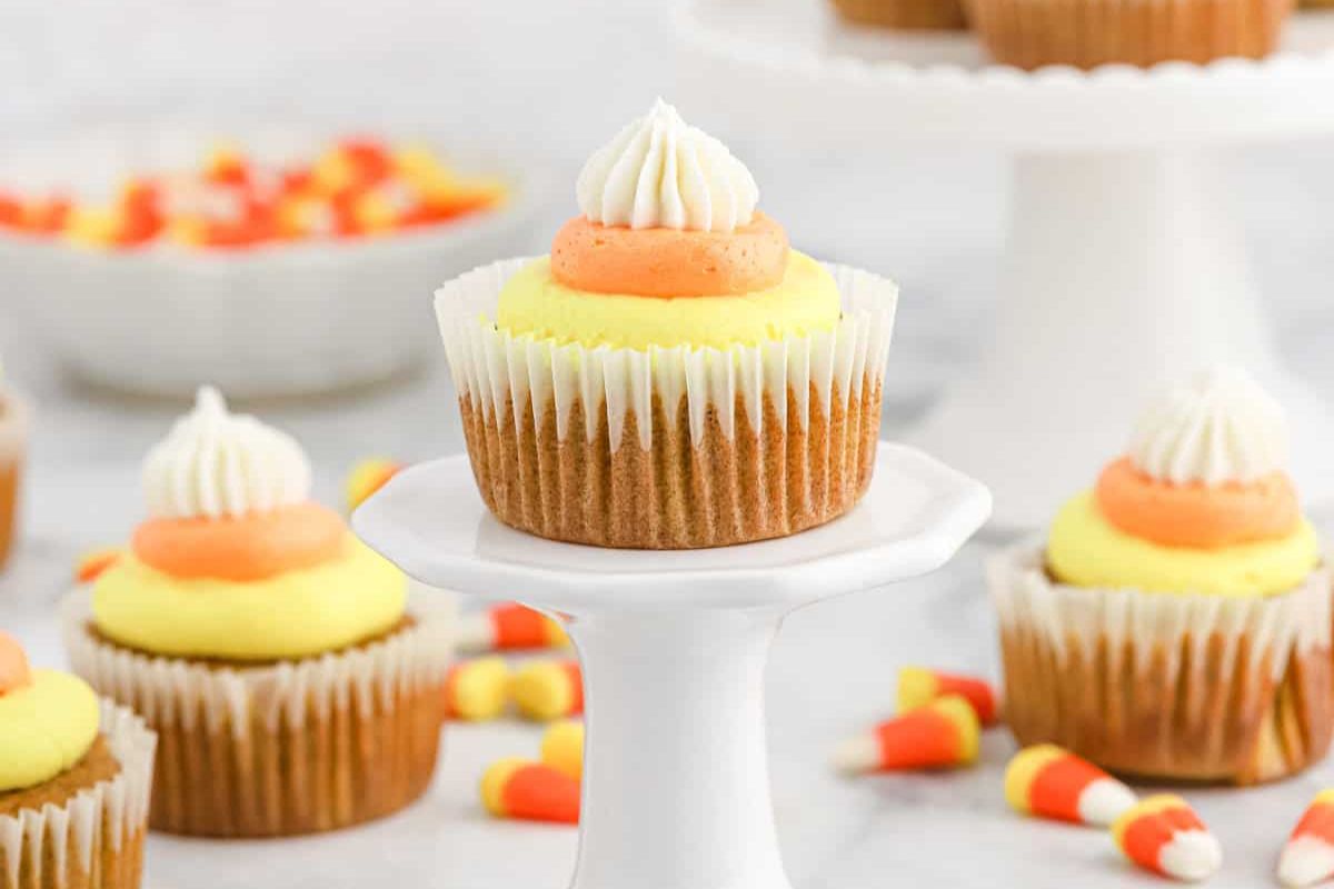 Cupcakes with candy corn icing on a pedastal.