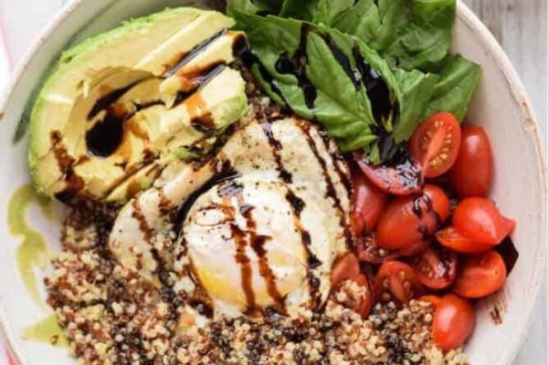A bowl of quinoa, avocado, tomatoes and eggs.