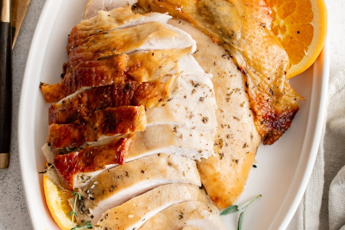 Roast Turkey Breast slices on a white serving dish. 