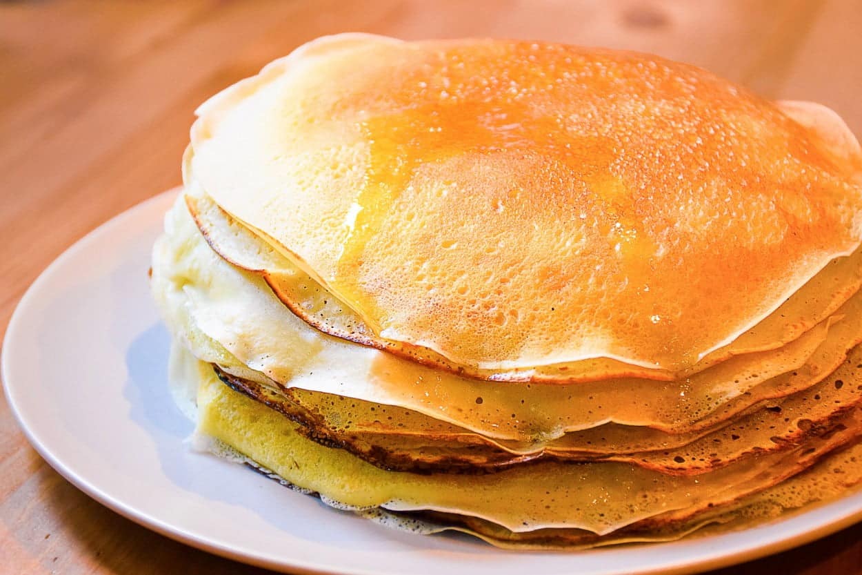 Russia’s Blini crepes stacked on a white plate.