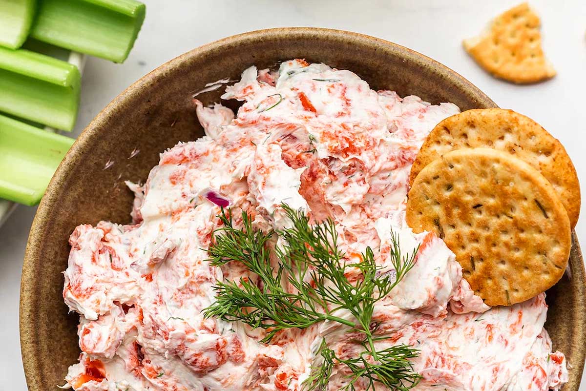 Smoked salmon dip with crackers on the side.