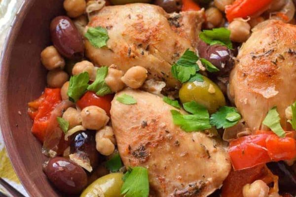 Slow cooker chicken with olives and peppers in a dish.