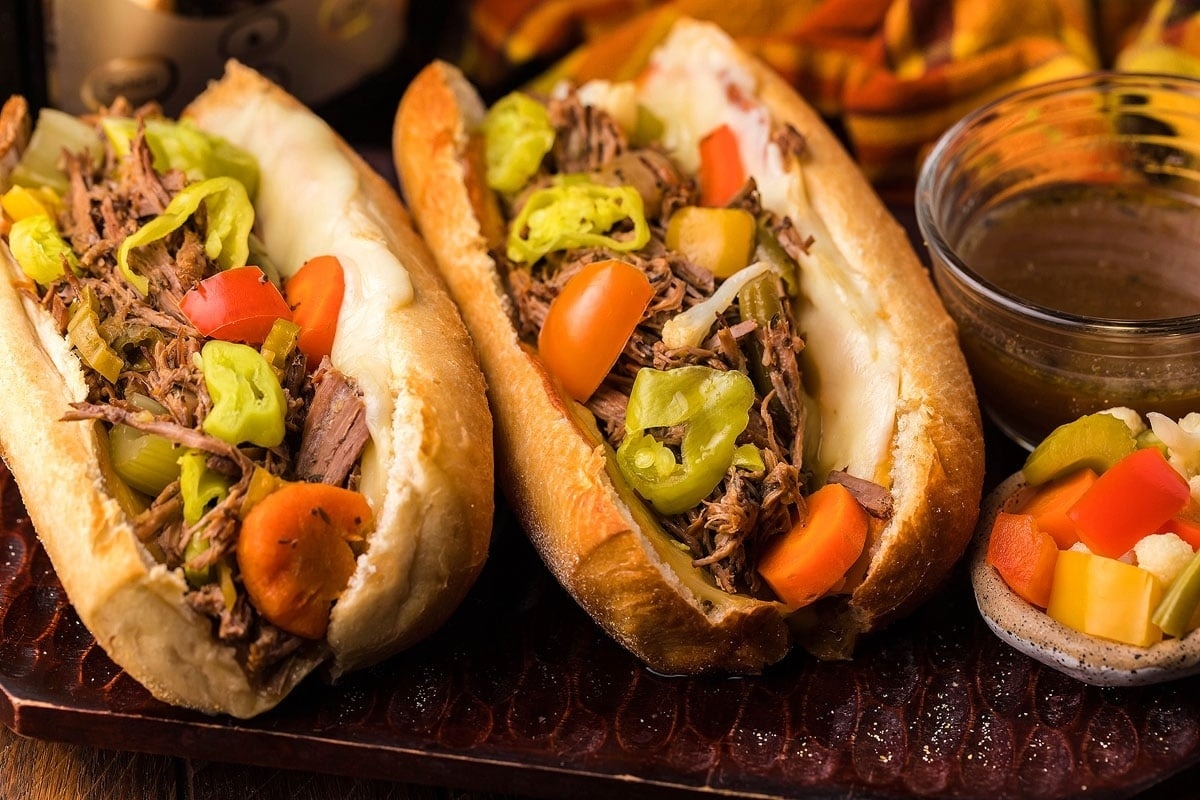 Two sandwiches with meat and vegetables on a tray. This is one of the best fall comfort food recipes.