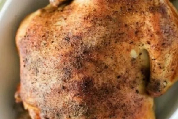 Slow cooker whole chicken in a dish.