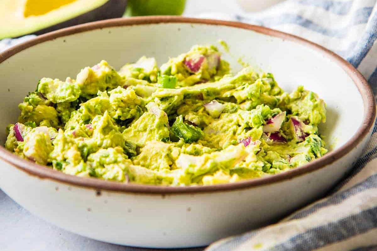Spicy guacamole in a white bowl.
