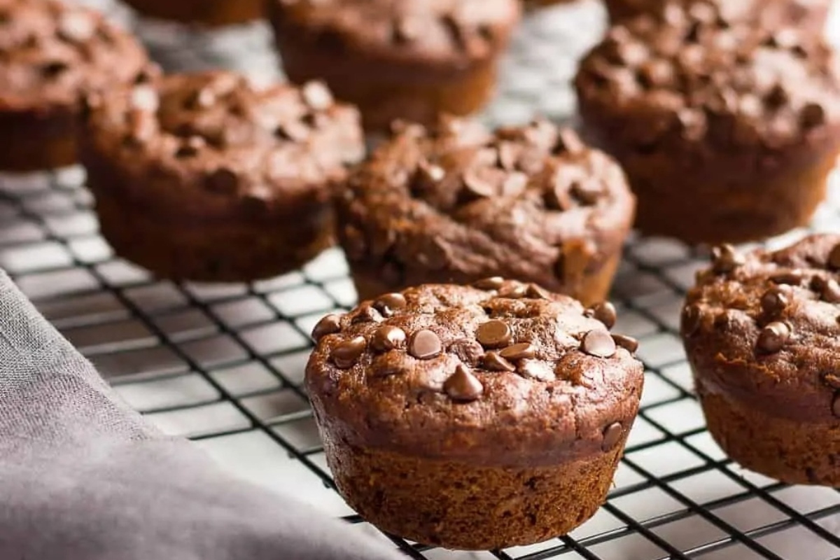 Chocolate banana muffins cooling on a rack.