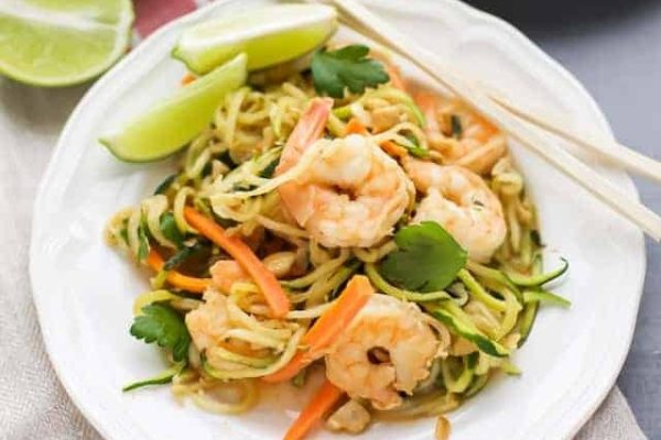 Zucchini Noodle Stir Fry with Shrimp on a white plate with chopsticks.
