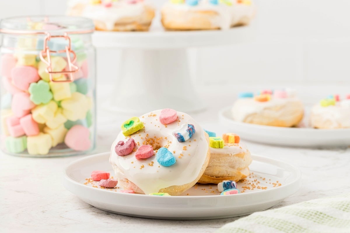 Air fryer lucky charms donuts on a white plate.